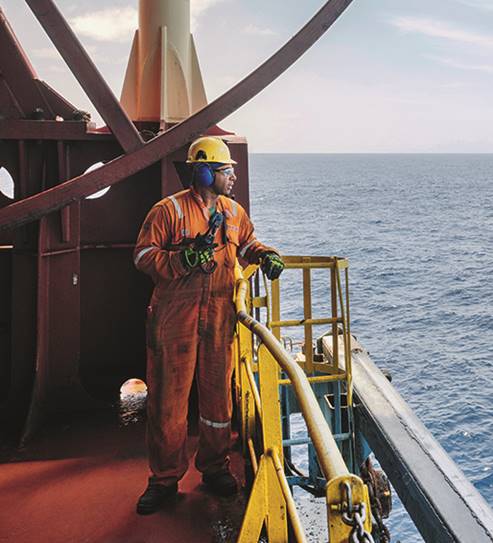 A person standing next to a body of water

Description automatically generated