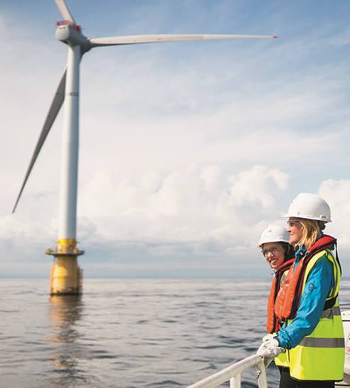 A person standing next to a body of water

Description automatically generated