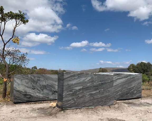 A large stone blocks in a field
Description automatically generated